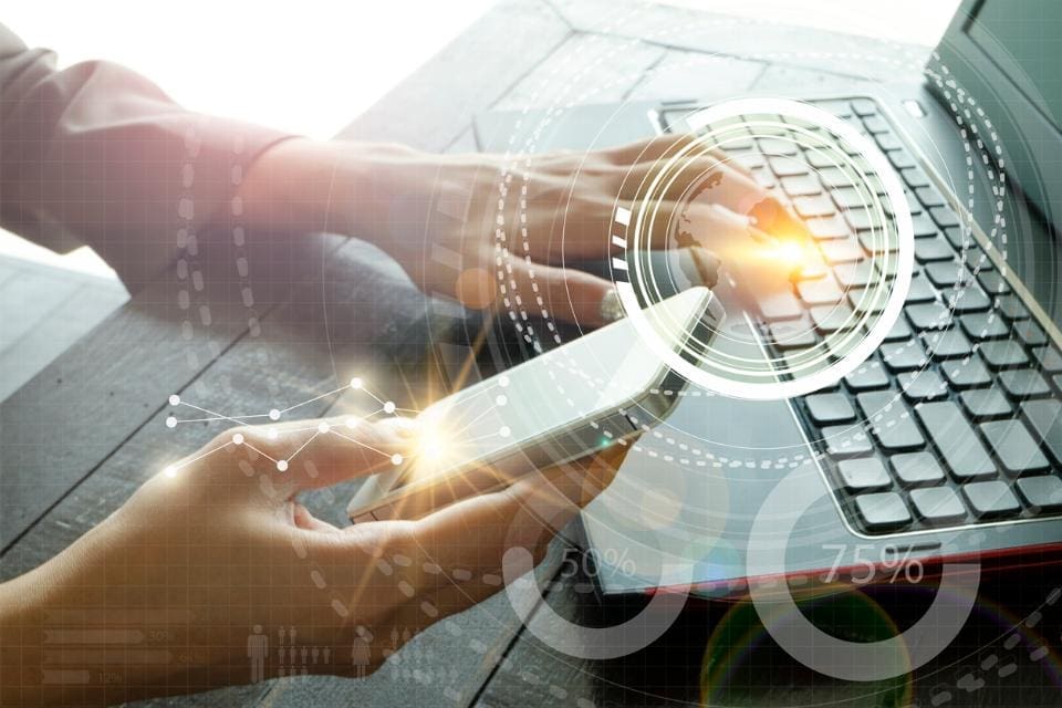 Close up of a woman's hands working on laptop and holding her cellphone with a glob design overlay